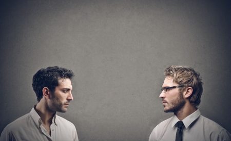 profile two young businessmen on a gray backgroundの写真素材