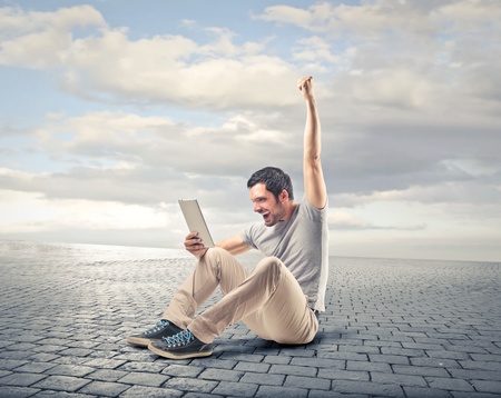 man lifting up his arm smilingの写真素材