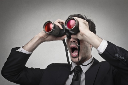 businessman looking at something with a binocularsの写真素材