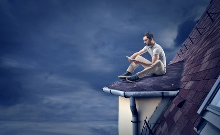 man on the roof of a houseの写真素材