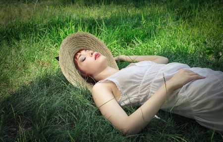 young woman sleeping on the grassの写真素材
