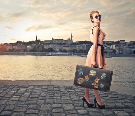 fashion woman with her suitcase on holiday