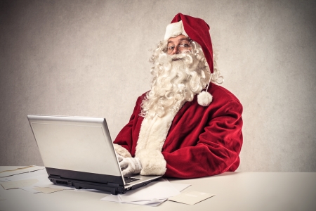 Santa Klaus using a laptopの写真素材