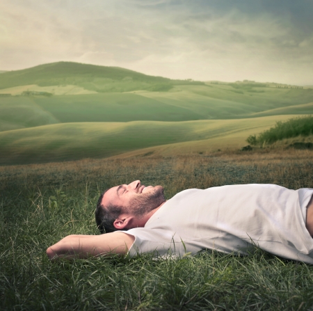 man relaxing on the grassの写真素材