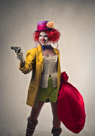clown holding a gunの写真素材