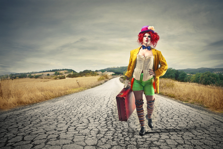 clown leaving with her suitcaseの写真素材