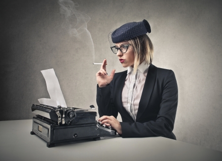 woman typing and smoking の写真素材