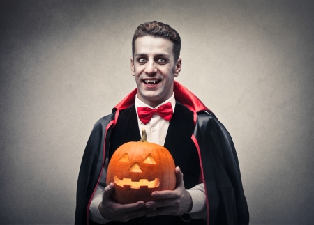 vampire holding a pumpkinの写真素材