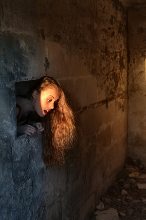 Popping out of a wallの写真素材