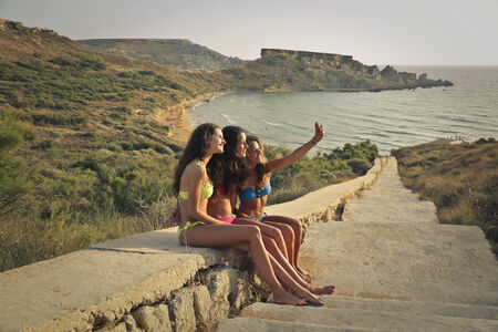 Three friends taking a selfieの写真素材