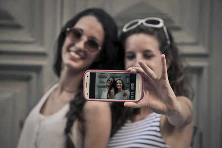 Two girls doing a selfieの写真素材