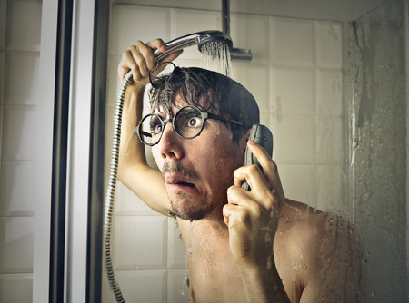 Calling on the phone in the showerの写真素材