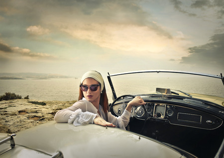 Classy woman in a vintage carの写真素材