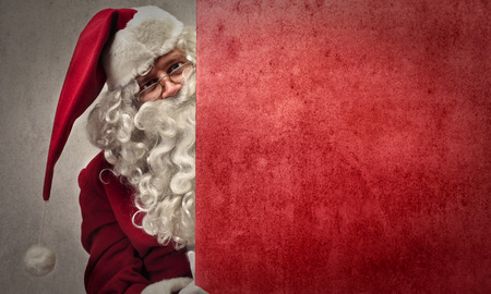 Santa Claus hiding behind a wallの写真素材