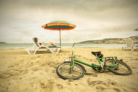 Green bike at the beachの写真素材
