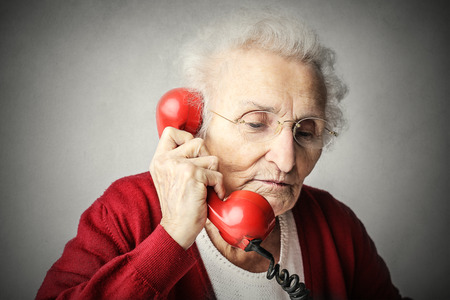 Elderly woman doing a phone callの写真素材
