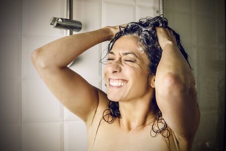 Happy woman in the showerの写真素材