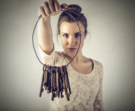 a bunch of keys in a woman\'s handsの写真素材