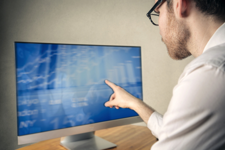 Businessman pointing at a screenの写真素材