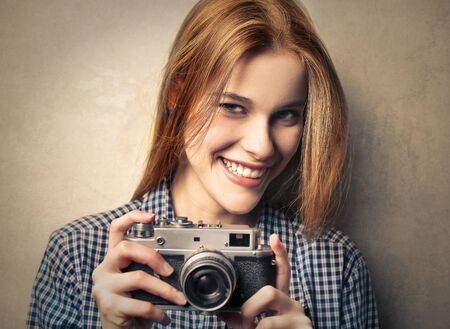 Blonde smiling girl taking a pictureの写真素材