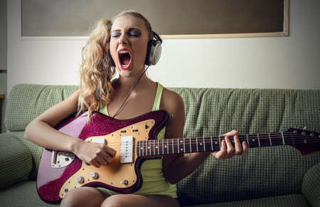 Blonde girl playing the  guitarの写真素材
