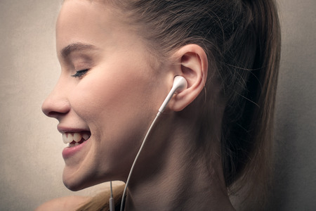 Blonde girl listening to musicの写真素材