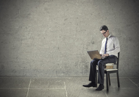 Businessman sitting on a chair in isolationの写真素材