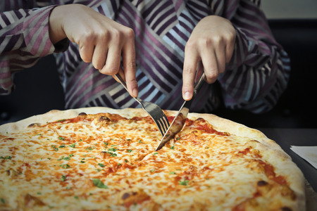 Woman eating pizzaの写真素材
