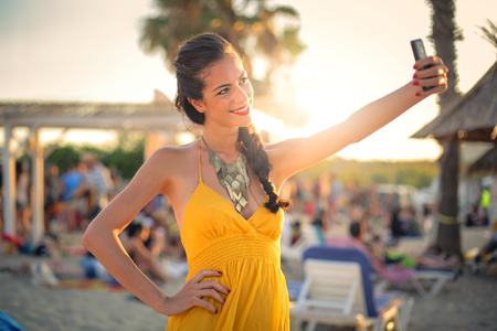 Woman taking a selfie on vacationの写真素材