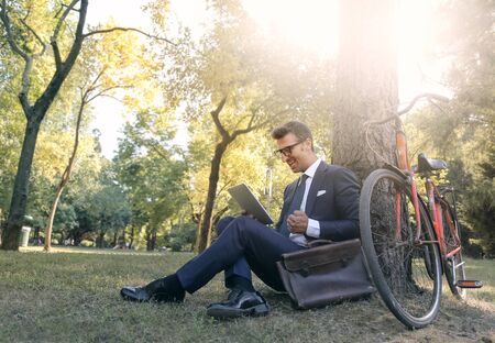 Businessman sitting at the parkの写真素材