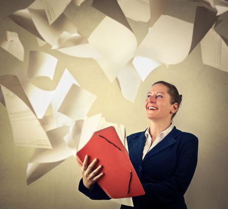 Secretary throwing away sheets of paperの写真素材