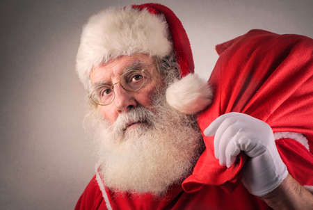 Santa Claus carrying a red bagの写真素材