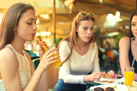 Three girls at the cafeの写真素材