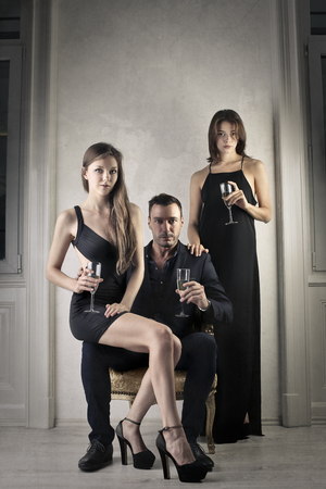 Powerful man surrounded by sensual womenの写真素材