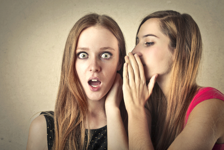 Whispering secrets to a friendの写真素材