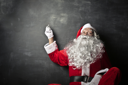 Santa Claus pointing at the balckboardの写真素材
