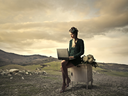 Using a laptop in the desertの写真素材