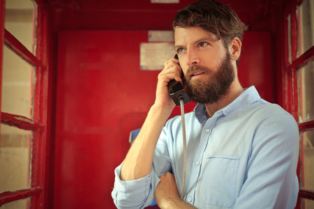 Bearded man in a phone box