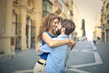 In love man lifting hi girlfriend in a hugの販売画像
