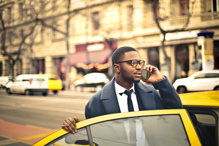 Businessman catching a taxiの写真素材
