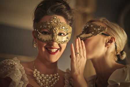 Masked ladies whisperingの写真素材