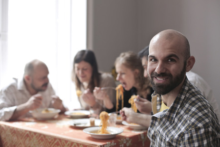 Friends eating dinner togetherの写真素材
