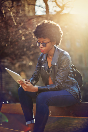 Fashionable girl holding a tabletの写真素材