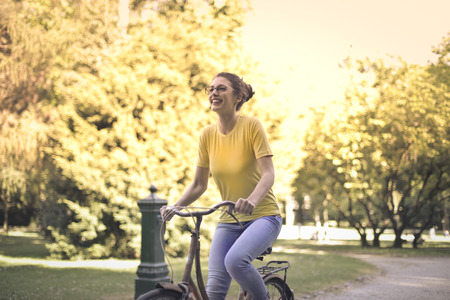 Young woman riding a bikeの写真素材