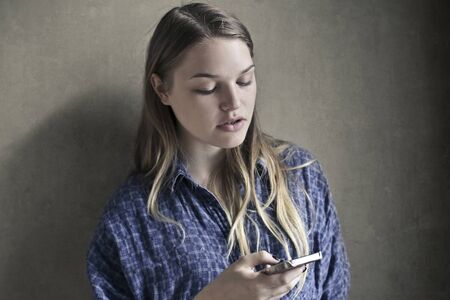 Blonde woman using her smartphone