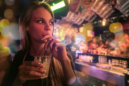 Blonde woman enjoying a drinkの写真素材