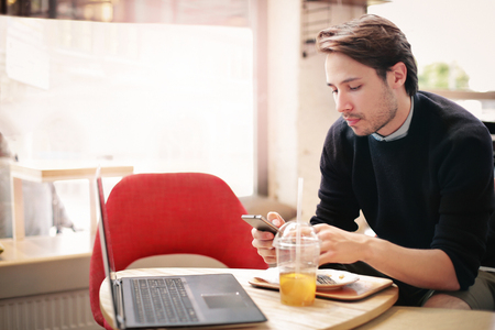 Young man working in a cafeの写真素材