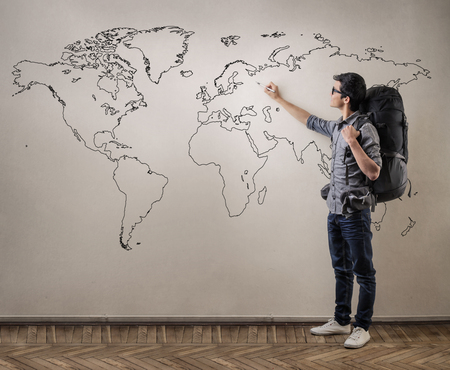 Young man dreaming of traveling all over the world