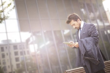 Businessman sending a text messageの写真素材