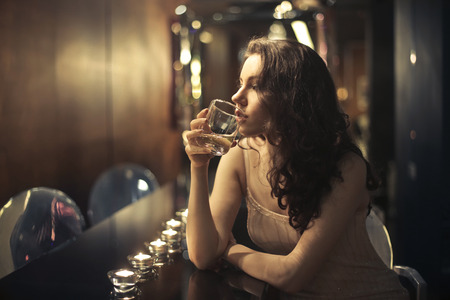 Lonely girl drinking a glass of wine